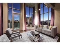 Bright living room with hardwood floors, floor-to-ceiling windows, and views of the Las Vegas strip at 360 E Desert Inn Rd # 807, Las Vegas, NV 89109