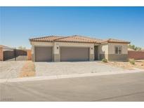 Charming single-story home featuring a three-car garage and a desert-style front yard at 37 Late Harvest Ave, Pahrump, NV 89060