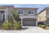 Two-story home showcasing an attached two-car garage and desert landscaping at 5661 Brimstone Hill Ave, Las Vegas, NV 89141