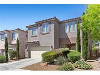 Charming two-story home with desert landscaping in front yard at 6049 Paddleboat St, North Las Vegas, NV 89031