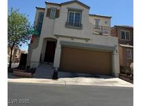 Inviting two-story home with a private balcony, and a convenient two-car garage at 7484 Butterton Ct, Las Vegas, NV 89139