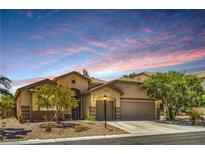 Charming single-story home featuring desert landscaping, an attached garage, and a warm, inviting facade at 8089 Black Orchid Ave, Las Vegas, NV 89131