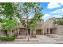 Inviting two-story home featuring a balcony, front porch, single-car garage, and well-kept landscaping at 9141 Careful Canvas Ave, Las Vegas, NV 89149
