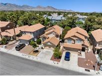 Inviting two-story home featuring desert landscaping and a charming tile roof at 9520 Rancho Palmas Dr, Las Vegas, NV 89117