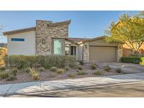 Stylish single-story home with stone accents, a two-car garage, and tidy landscaping at 9765 Skye Star Ave, Las Vegas, NV 89166