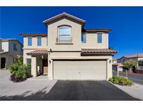 Two-story home featuring a two-car garage, desert landscaping and tile roofing under a clear blue sky at 10342 Adrianna Ave, Las Vegas, NV 89129