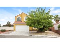 Charming two-story home featuring a well-maintained lawn, complemented by a spacious two-car garage at 1117 Coral Crystal Ct, North Las Vegas, NV 89032