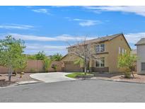 Two-story home with a driveway, attached garage and well-maintained landscaping on a sunny, clear day at 11695 Rossovino St, Las Vegas, NV 89183