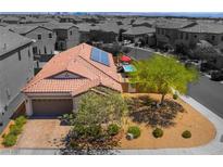 Charming home with a red tiled roof, solar panels, and a well-maintained front yard with a beautiful pool at 184 Cullerton St, Las Vegas, NV 89148