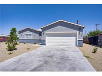 Charming single-story home with a well-maintained front yard and a two-car garage at 2130 Revere St, North Las Vegas, NV 89030
