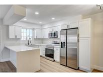 Bright kitchen featuring white cabinets, stainless steel appliances, and a large countertop at 2725 S Nellis Blvd # 2036, Las Vegas, NV 89121