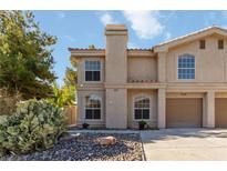 Charming two-story home with a desert-landscaped front yard and attached two-car garage at 2834 Crystal Lantern Dr, Henderson, NV 89074
