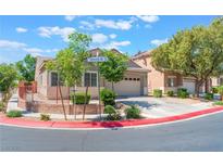 Charming single-story home showcasing a well-manicured front yard and a two-car garage at 329 Gemstone Hill Ave, North Las Vegas, NV 89031