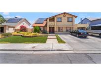Two-story house with a two-car driveway and solar panels on the roof at 4356 Sabadell St, Las Vegas, NV 89121