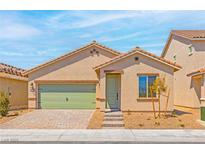 Charming single-story home featuring a green two car garage door and welcoming front entrance at 4417 Pioche Ave, North Las Vegas, NV 89032