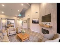 Bright living room featuring hardwood floors, a fireplace, and ample seating at 5010 Crooked Stick Way, Las Vegas, NV 89113