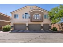 Inviting townhome featuring a three-car garage, balcony, and desert landscaping at 5509 Ante Up Ct # 102, Las Vegas, NV 89122
