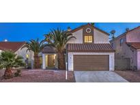 Charming two-story home featuring a well-maintained yard with mature palm trees at 6 Megan Dr, Henderson, NV 89074