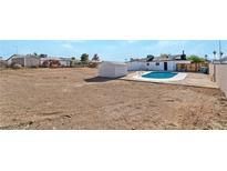 Expansive backyard with an in-ground pool, storage shed and potential for landscaping at 934 Lewis Ct, Henderson, NV 89015
