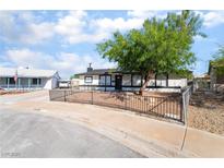 Charming single-story home with a well-maintained front yard and wrought iron fence for added curb appeal at 934 Lewis Ct, Henderson, NV 89015