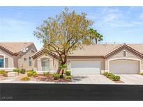 Charming single-story home featuring a well-maintained yard, mature tree, and two-car garage at 9688 Meeks Bay Ave, Las Vegas, NV 89148