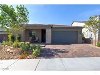 Beautiful single-story home with a two-car garage and a well-manicured, low-maintenance front yard at 10049 Cardinal Knoll Ave, Las Vegas, NV 89143