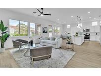 Open-concept living room featuring modern furnishings, neutral tones, and natural light at 10801 Clarion Ln, Las Vegas, NV 89134