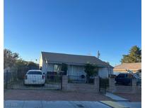 Modest single-story home featuring a gated yard and driveway with parking, offering a practical and convenient living space at 212 S 16Th St, Las Vegas, NV 89101