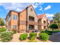 Inviting two-story condo with stucco siding, red tile roof, and well-maintained landscaping at 2200 S Fort Apache Rd # 2015, Las Vegas, NV 89117