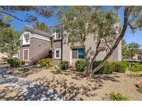 Inviting condo with well-maintained landscaping and cozy exterior staircase at 2325 Windmill Pkwy # 321, Henderson, NV 89074