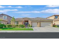 Attractive single-story home boasts a three-car garage and well-maintained landscaping at 2410 Sunburst View St, Henderson, NV 89052