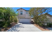 Inviting two-story home with a two-car garage, desert landscaping, and a bright blue sky at 3131 Binaggio Ct, Las Vegas, NV 89141