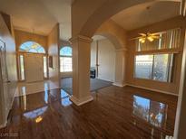 Inviting living room featuring hardwood floors, archways and a well-lit entrance at 3136 Jane Austin Ave, North Las Vegas, NV 89031