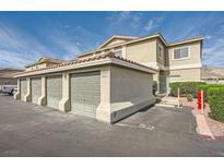 Charming townhome featuring attached garage with parking and lush landscaping under a sunny sky at 3253 Mystic Ridge Ct, Las Vegas, NV 89129