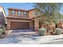 Charming two-story home with a brick-accented facade, a two-car garage, and landscaped front yard at 334 E Neal Ave, Las Vegas, NV 89183
