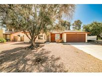 Charming single-story home with a mature tree in the front yard and a two-car garage at 3596 Bronco Rd, Las Vegas, NV 89103