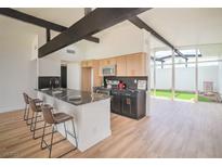 Modern kitchen with a breakfast bar, stainless steel appliances, and views to an outdoor atrium at 6320 Dayton Ave, Las Vegas, NV 89107