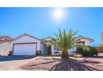 Charming single-story home features a desert landscape, two-car garage, and vibrant curb appeal at 708 Canyon Country Cir, Henderson, NV 89002
