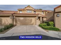Charming home exterior with a two-car garage, well-maintained landscaping, and a tile roof, enhancing its curb appeal at 7365 Mission Hills Dr, Las Vegas, NV 89113