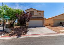 Charming home featuring a two-car garage, complemented by drought-resistant landscaping and mature trees at 7912 Horn Beam Ct, Las Vegas, NV 89131