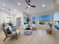 Bright living room with vaulted ceilings, modern furnishings, and large windows offering picturesque views at 9369 Villa Ridge Dr, Las Vegas, NV 89134