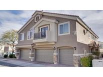 Attractive townhome featuring a three-car garage and desert landscaping at 9994 Government Point Way # 101, Las Vegas, NV 89183