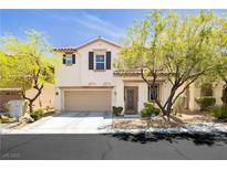 Charming two-story home with desert landscaping, an attached two-car garage and a welcoming front porch at , Las Vegas, NV 89178