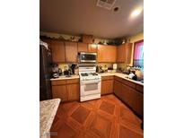 Traditional kitchen featuring wood cabinets and gas range at 1001 Declaration Dr, Las Vegas, NV 89110