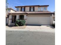 Two-story home features a terracotta roof, a two-car garage, and low-maintenance landscaping at 1043 Monte De Oro Ave, Las Vegas, NV 89183