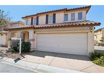 Inviting two-story home featuring a tile roof and a spacious two-car garage at 1043 Monte De Oro Ave, Las Vegas, NV 89183