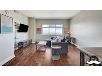 Spacious living room featuring hardwood floors, large windows, and a comfortable sectional sofa at 150 Las Vegas Blvd # 1118, Las Vegas, NV 89101