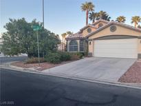 Charming single-story home featuring a well-maintained yard, a two-car garage and desert landscaping at 1800 Quail Point Ct, Las Vegas, NV 89117