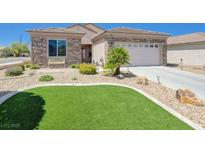Charming home with a stone facade, well-manicured landscaping and artificial grass at 2545 Nashira St, Henderson, NV 89044