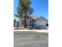 Charming single-story home features a two-car garage, red-tiled roof and neutral paint at 2721 Coffee Pot Ct, Las Vegas, NV 89106